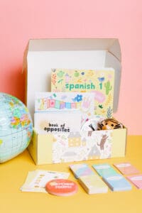 homeschool languages curriculum box with books and puppet
