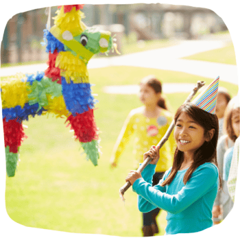 child hitting a piñata