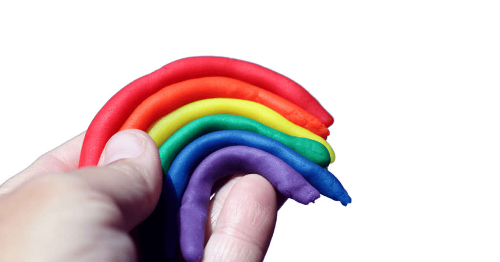 hand holding a rainbow made out of Play Doh