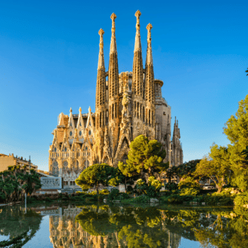photo of la sagrada familia cathedral in Barcelona with the reflection in the lake
