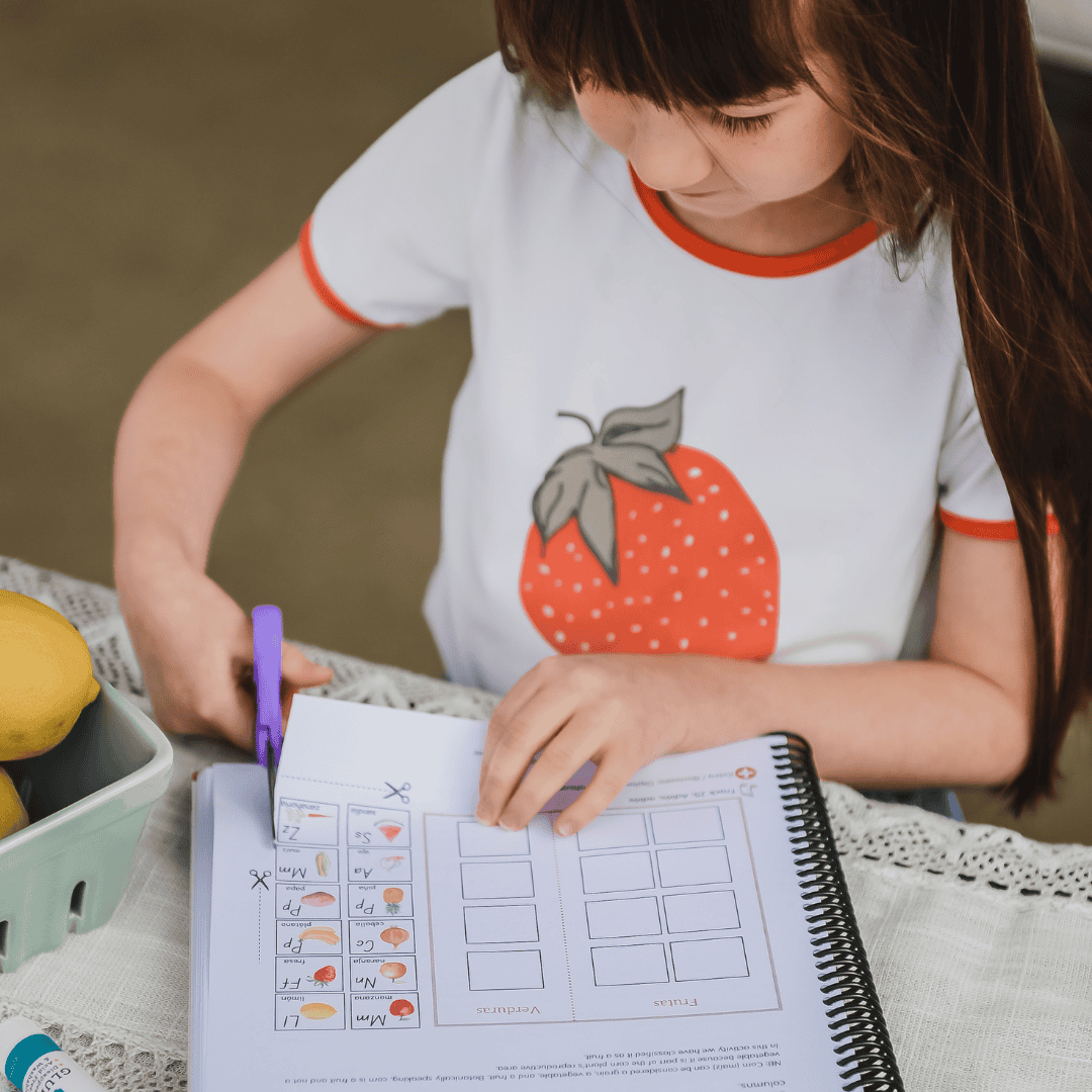 Child using scissors to cut a worksheet activity