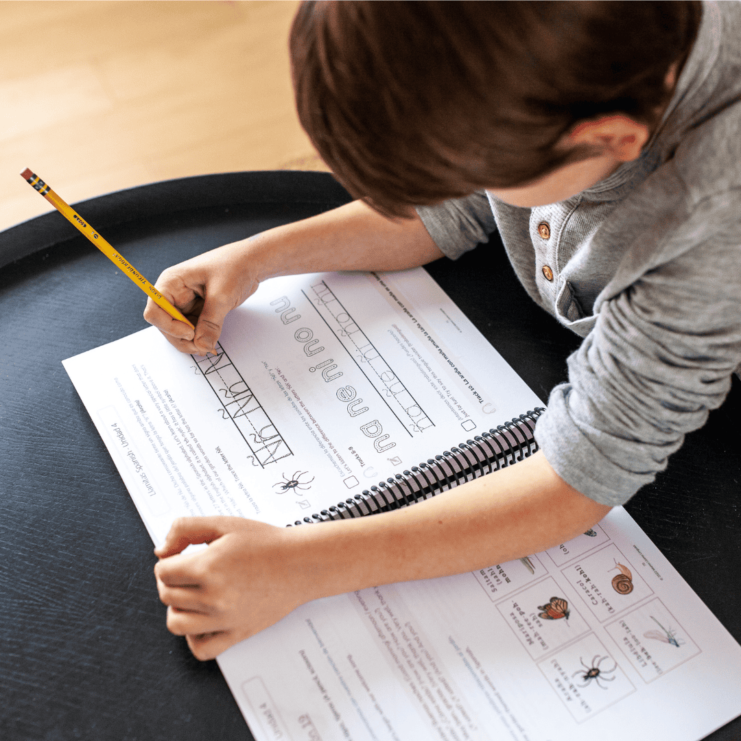 Boy tracing the letter ñ in Spanish