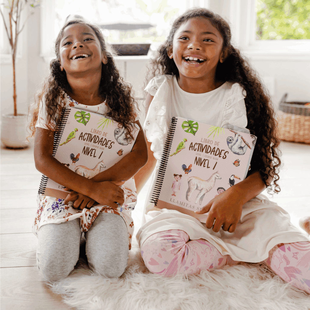 two girls holding the level 1 textbooks